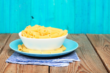 Dry italian pasta in a ceramic bowl