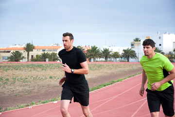 Fototapeta premium Two men running on running track