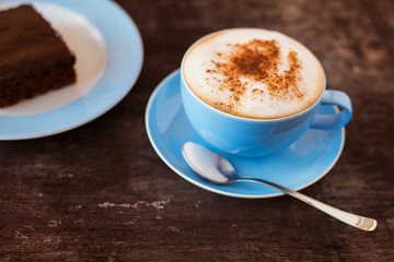 Coffee and cake on a wooden table background