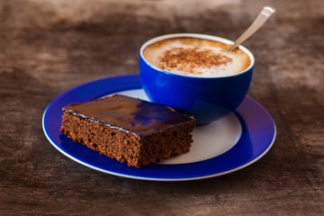 Coffee and cake on a wooden table background