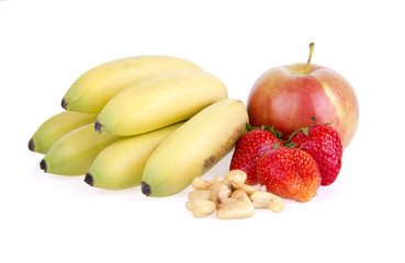 Delicious fresh fruits and cashew nuts on white background