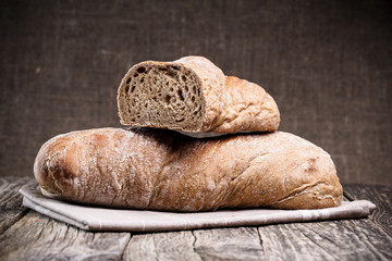 Tasty bread on wooden background.
