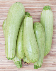 young zucchini on a wooden background