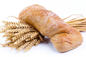 Tasty bread with wheat on a white background.