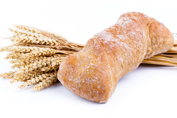 Tasty bread with wheat on a white background.