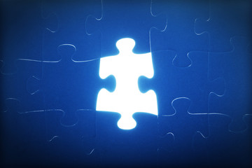 Jigsaw puzzle piece missing. Light glowing. Solution