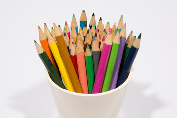 Colorful pencils in pail isolated on white background