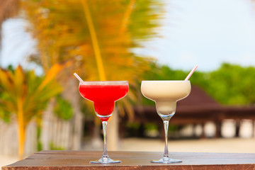 Two cocktails on tropical sand beach