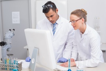 Scientists looking at computer