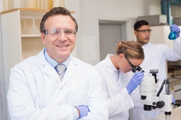 Smiling scientist looking at camera