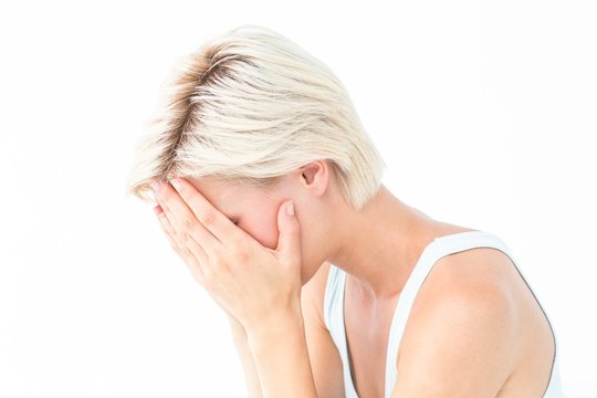 Sad Blonde Woman Crying With Head On Hands