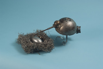 Metal Bird near its Nest © andrei_sikorskii