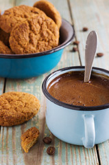Coffee in a metal mug on the wooden background