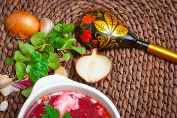 vegetable soup with potato, tomato, beetroot in bowl on table