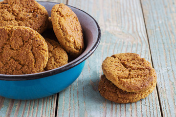 Oatmeal cookies in a metal bowl with coffee