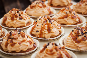 Obraz na płótnie Canvas Caramel cupcakes on a baking tray