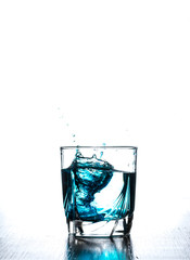 water splash in glass isolated on white