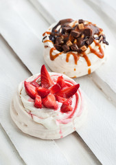 Two different versions of Pavlova meringue cake