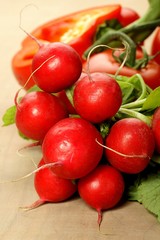 bunch of radishes on a wooden background