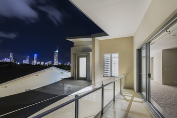 Fototapeta na wymiar Balcony exterior of mansion with night views of skyline