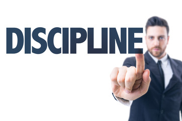 Business man pointing the text: Discipline