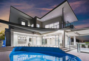 Mansion with pool and beautiful sky at dusk