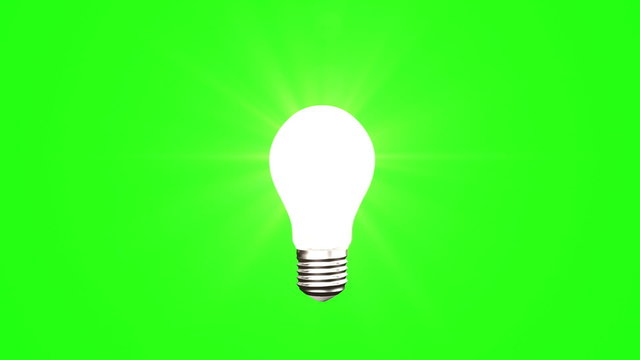 Light bulb on green background
