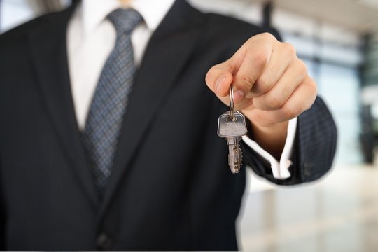 Real Estate. Businessman holding key
