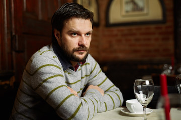 Young man drinking coffee in a restaurant