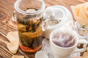 Tea cups with teapot on old wooden table