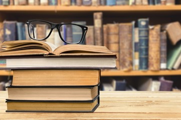 Analyze. Picture of a pile of books and eyeglasses, with a retro