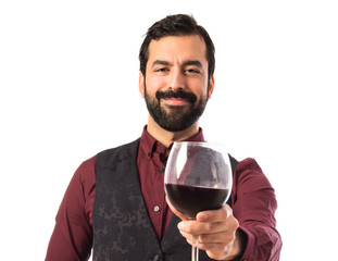 Man wearing waistcoat holding a wine glass