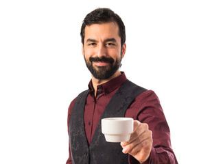 Man wearing waistcoat holding a cup of coffee