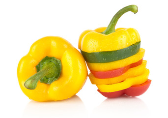 Closeup of multicolored slices bell pepper on white drops water