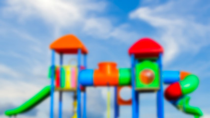 Defocused and blur image of children's playground  over cloudy b