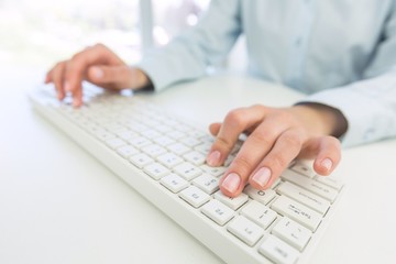 Network. Female office worker typing on the keyboard