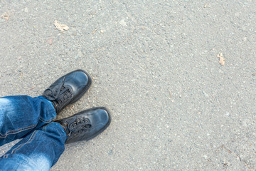 Fototapeta na wymiar Man feet on cobbled road