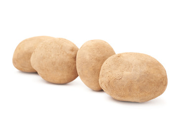 Fototapeta premium Four brown potatoes lined up