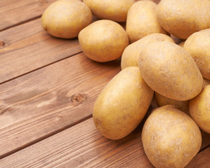 Pile of potatoes over the wooden surface
