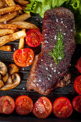 Fried steak with fries .