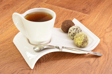 Black tea in a white mug and cake