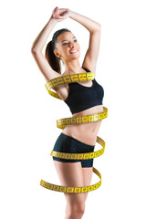 Fit young woman with a large measuring tape around her body