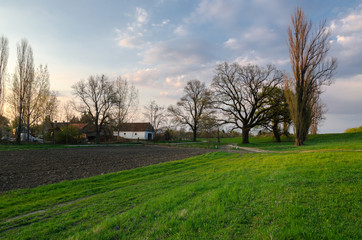 Fototapeta na wymiar Spring landscape showing farm on countryside at dusk