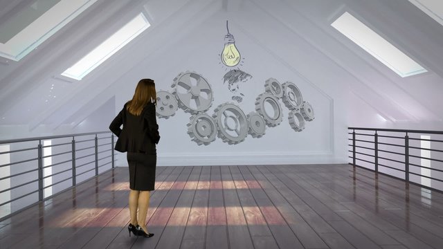 Businesswoman looking at cogs and wheels projection