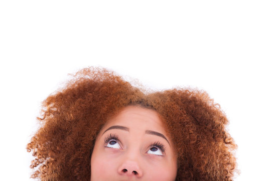 Young hispanic teenage girl looking up isolated on white backgro