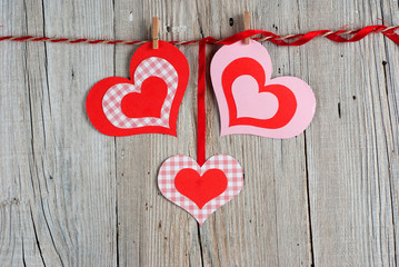 Paper hearts on old wooden background