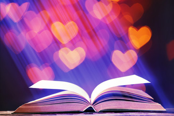 Book with light over dark background