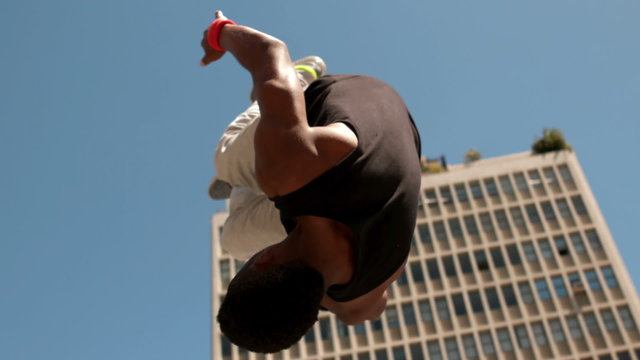Handsome young man doing backflip