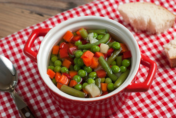 Vegetable soup on old wooden table
