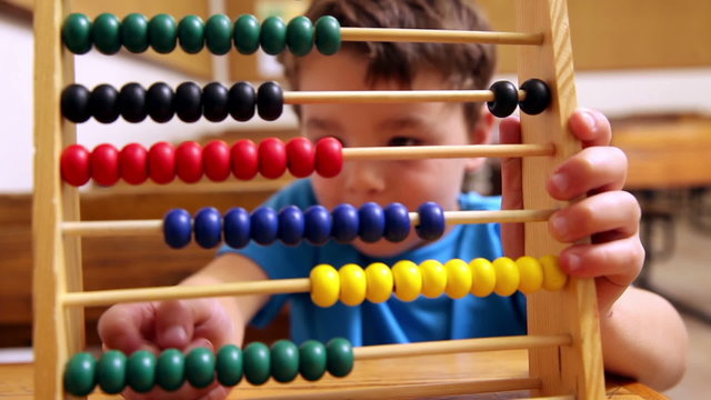 Cute pupil using abacus